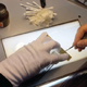 A restorer works on a section of celluloid (Photo: Criterion)